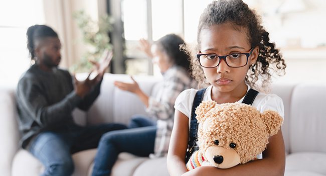 Sad stressed little african preteen girl feeling scared while her parents divorce, arguing, having marriage problems. Misunderstaning between partners. Psychology therapy.